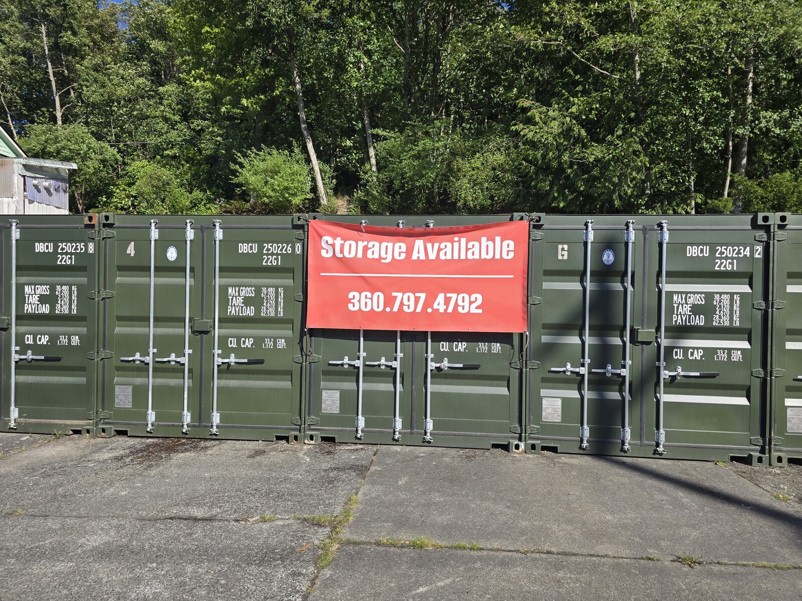 Shipping containers with storage available sign and phone number